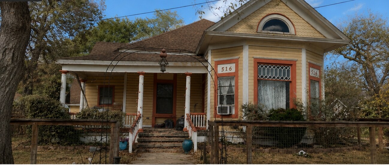 Historic Victorian home with faded yellow and orange paint before restoration